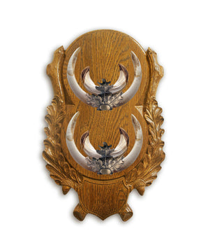 Carved double boar trophy shield made of oak